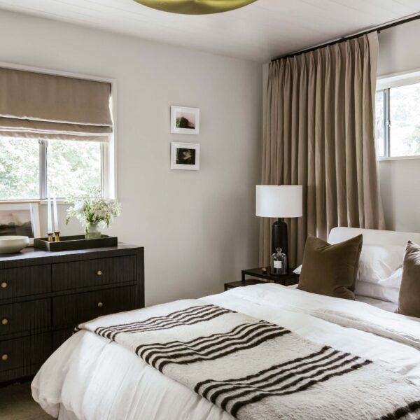 Full view of Guest Room 1 in neutral tones with contrasts of dark brown.