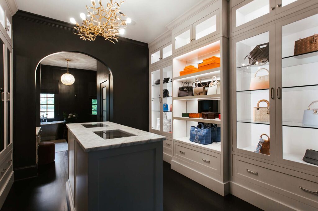 Angled view of Her closet with handbag display cases