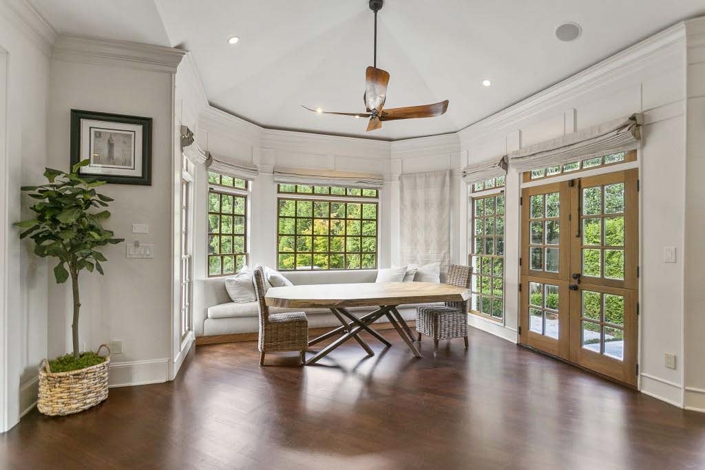 wide dining area, grey banquette, wooden dining table, woven dining chairs