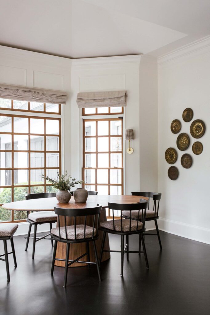 breakfast area with round dining table and cushioned chairs