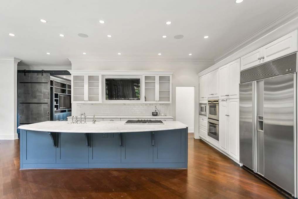 empty kitchen before renovation, white cabinets