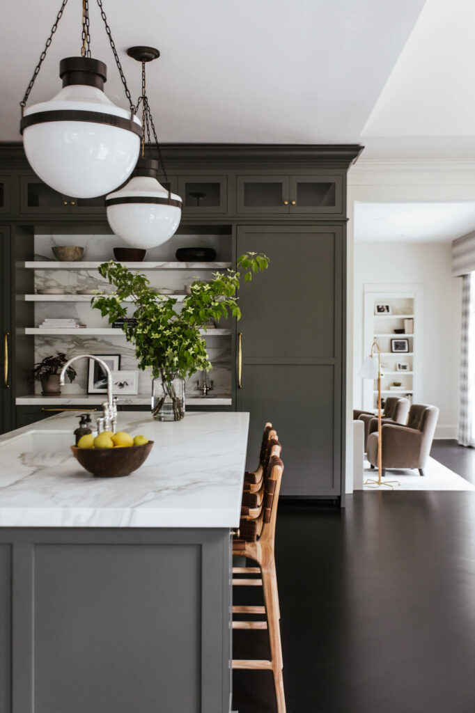 main kitchen with island, marble countertop, woven barstools, ceiling light fixtures