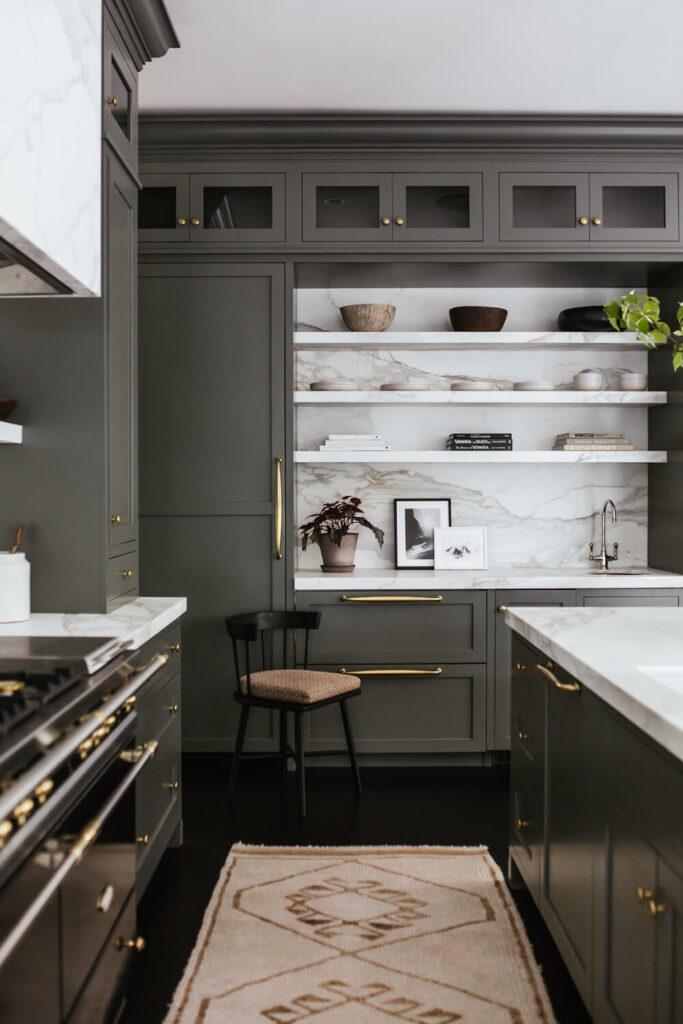 marble countertops and grey cabinets with tarnished brass handles